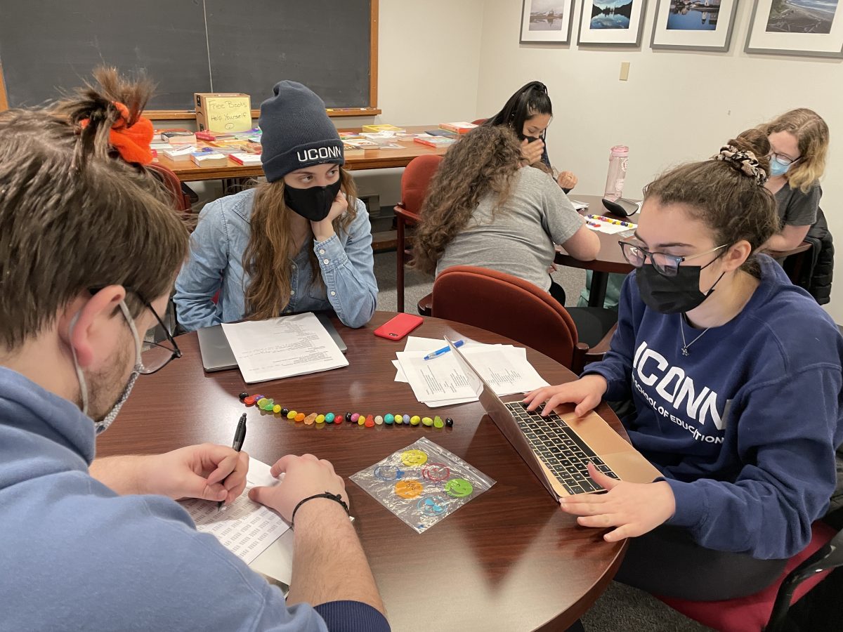 Honors students using candy to study sampling techniques